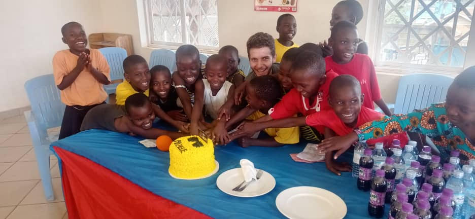 Michele photographed with a few of the young cohorts as they celebrate and cut cake for his birthday